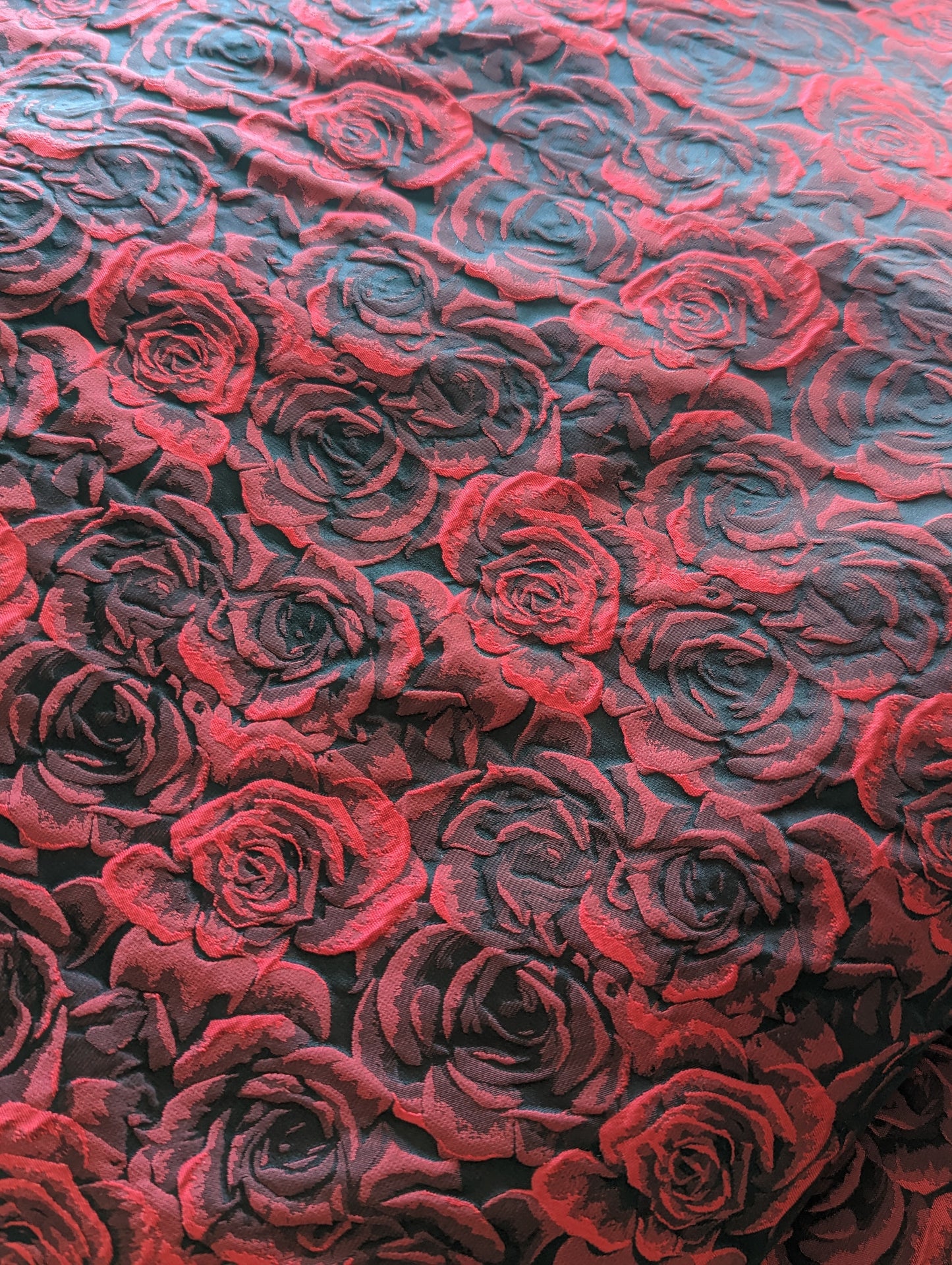 Close up image of red and black roses damask fabric.