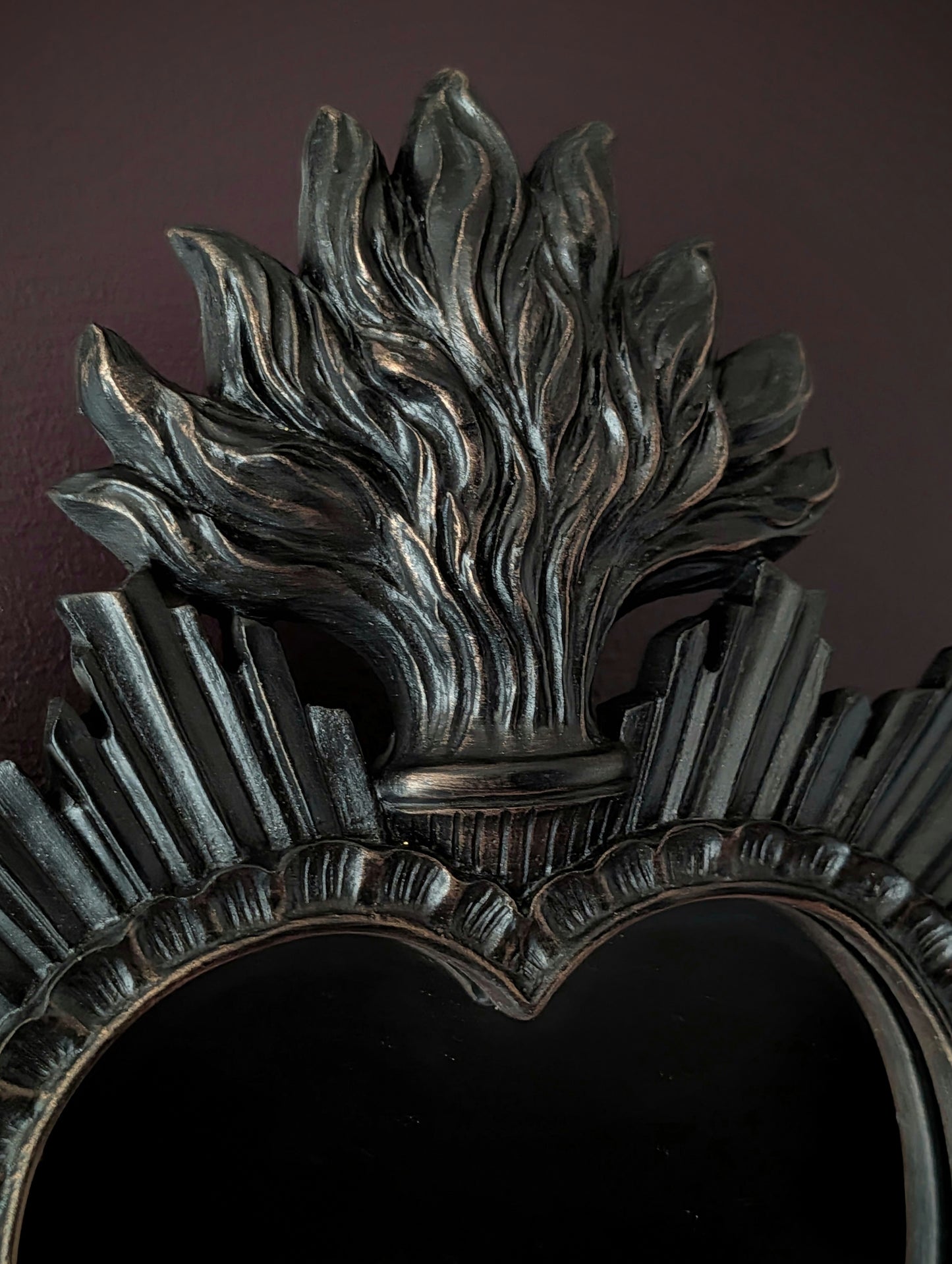 Detail shot of a black sacred heart shaped mirror