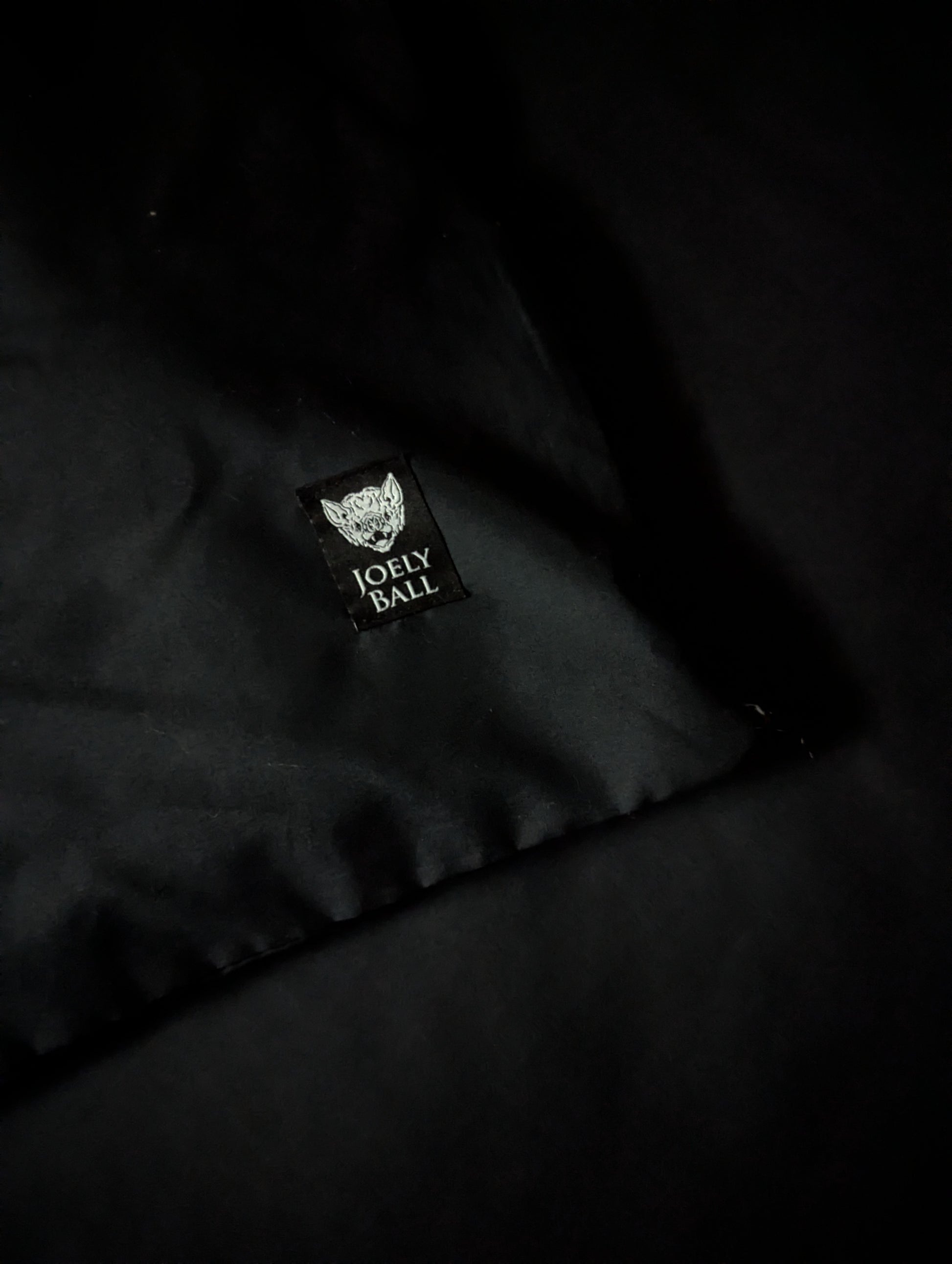 Black duvet with a 'Joely Ball' logo on a dark background