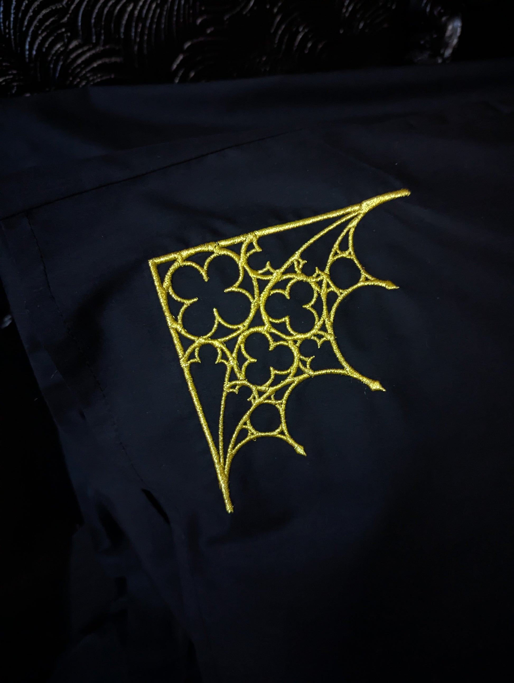 Gold Gothic architecture embroidered on a black pillowcase 