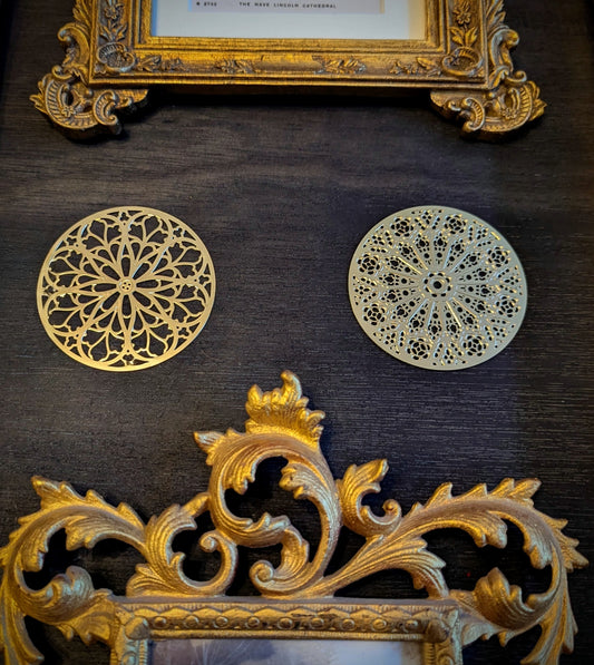 Decorative gold rose window gallery wall gap fillers on a dark wall with ornate gold frames.