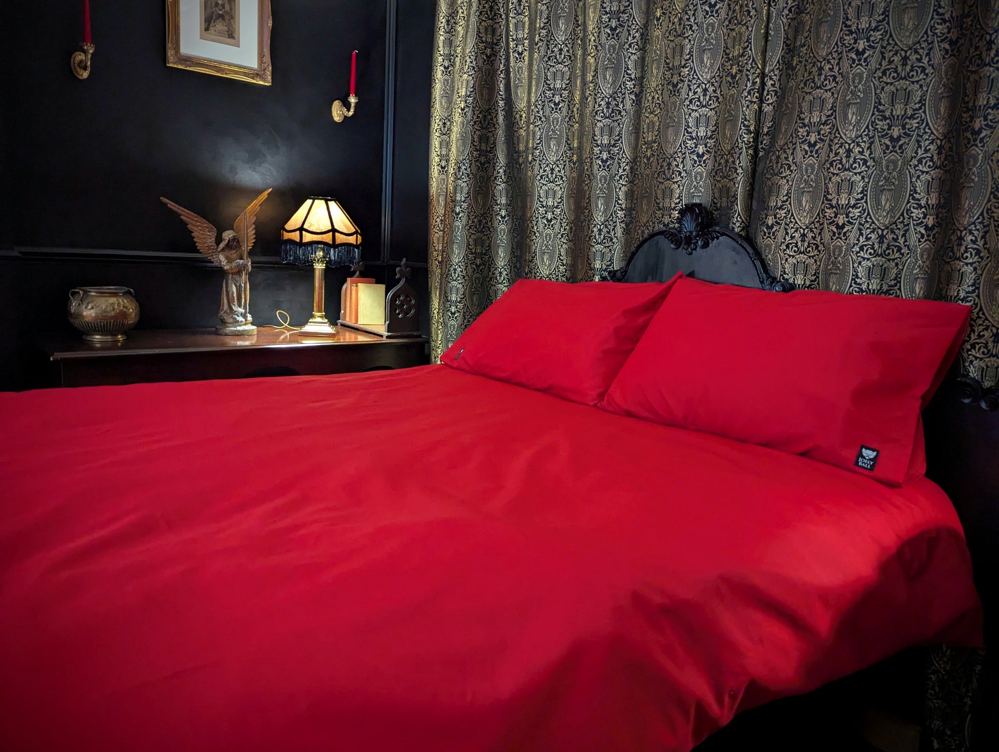 Red bedspread on a bed with decorative elements in the background
